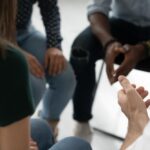Ivory Plains - Why Ivory Plains Offers Skilled Fentanyl Addiction Treatment - Edited. A group of individuals sit in a circle with only their hands in frame.