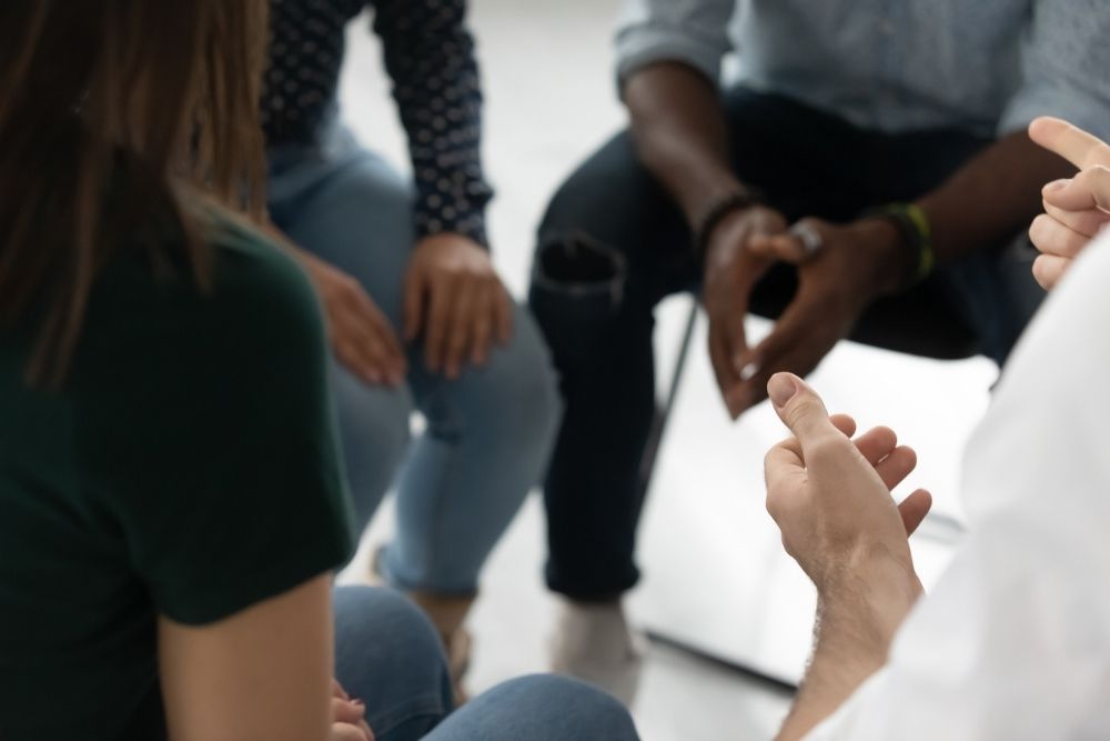 Ivory Plains - Why Ivory Plains Offers Skilled Fentanyl Addiction Treatment - Edited. A group of individuals sit in a circle with only their hands in frame.
